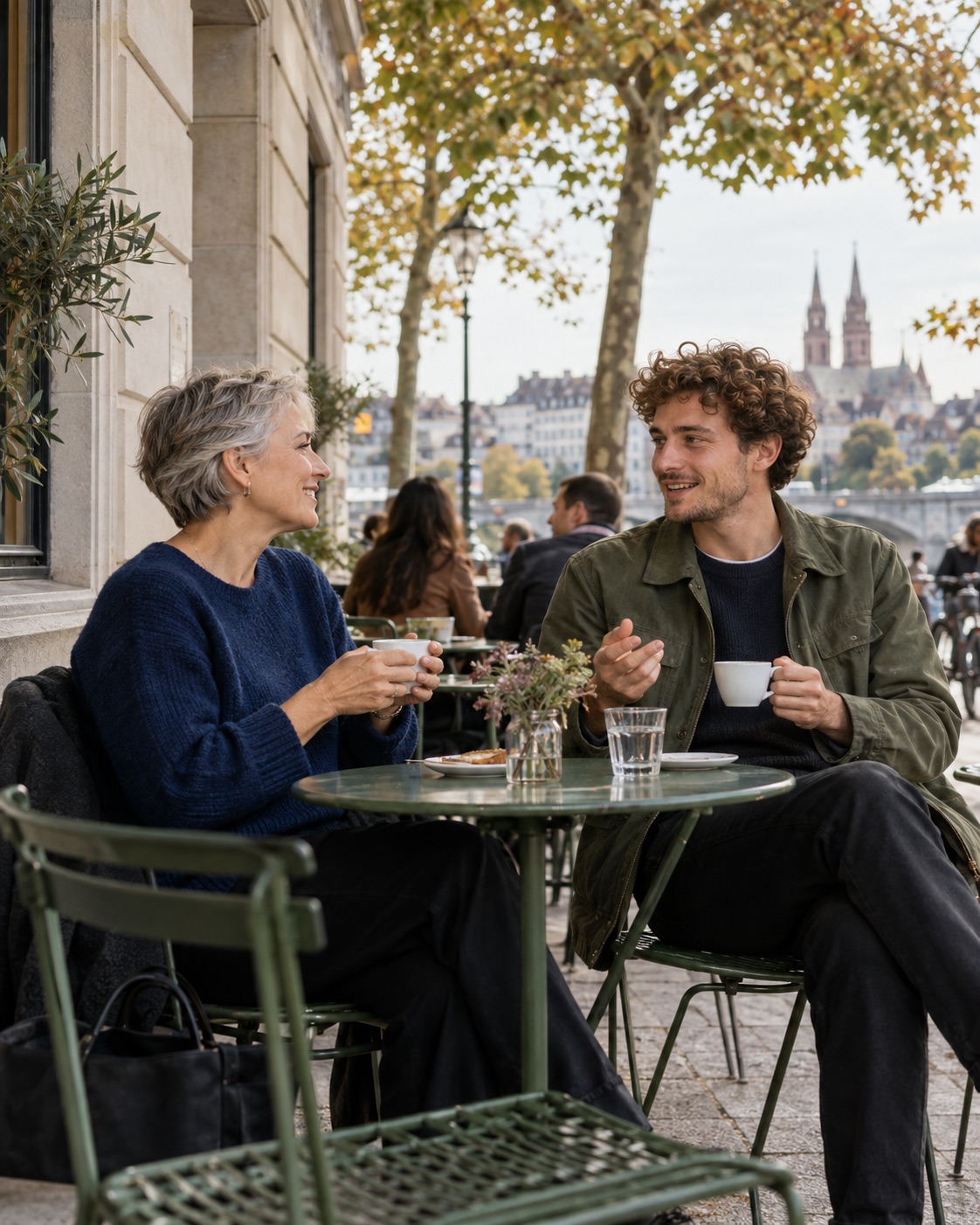Two future colleagues talking over coffee on an outdoor terrace.
